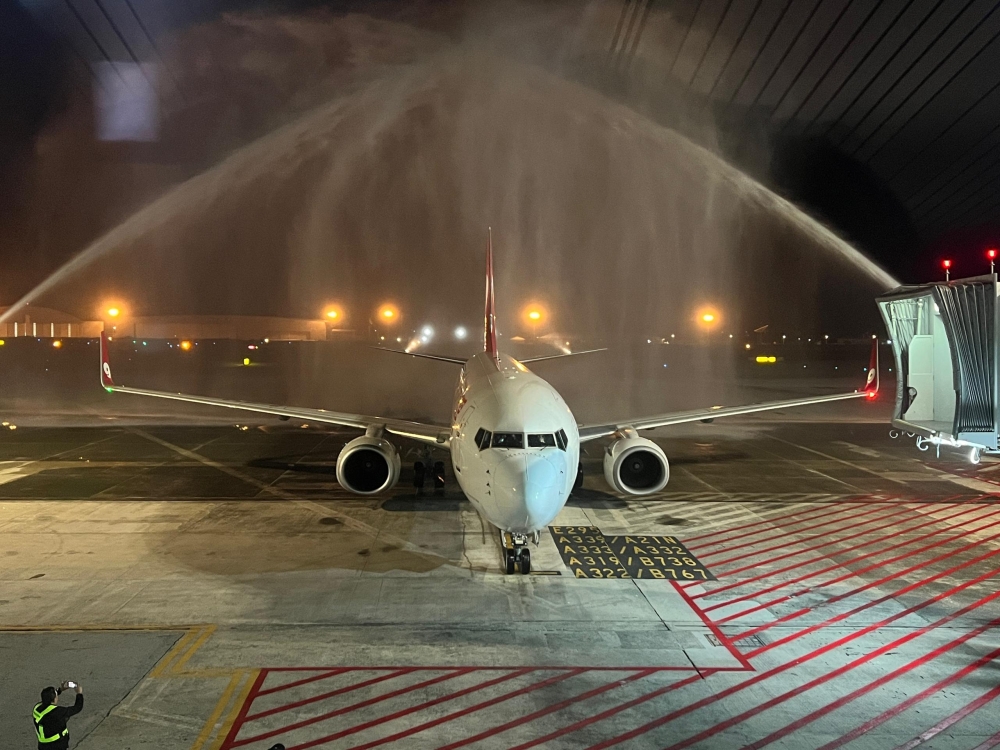 Flight AQ1295 from Haikou, China is welcomed at the Kuching International Airport with a water salute upon landing at 5.10am on November 15, 2025. — The Borneo Post pic