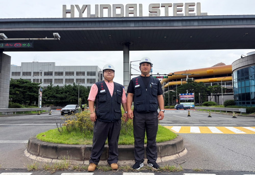 Choi Bum-kyu, a senior leader at Korean Metal Workers’ Union’s branch for Hyundai Steel’s temporary workers, and Kim Yong-ho, a unionised worker at Hyundai Steel, pose for photographs during an interview with Reuters in front of its plant in Dangjin, South Korea, September 12, 2025. — Reuters pic
