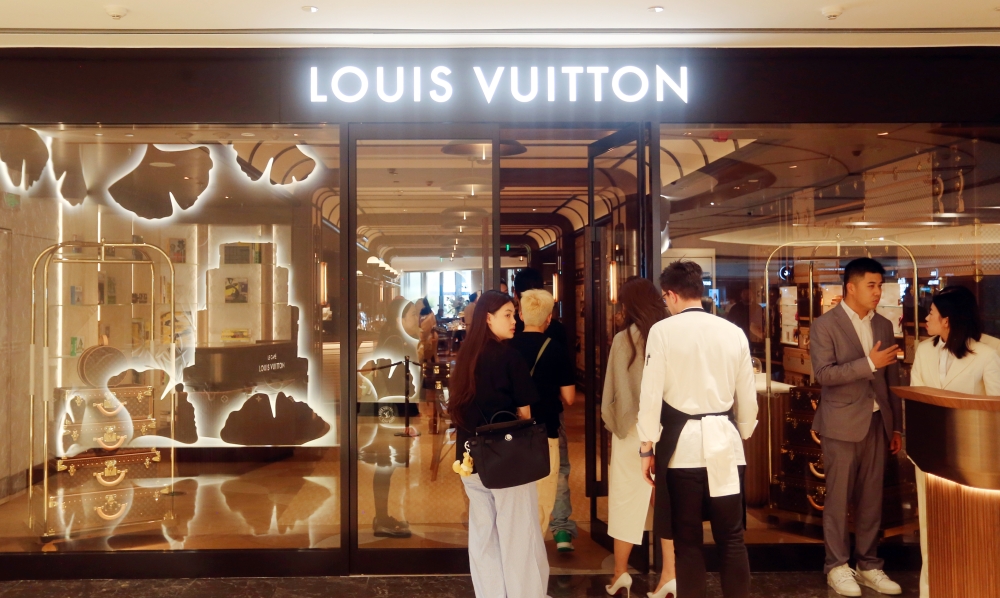 Tourists visit the world's only giant wheel-shaped building of French luxury giant Louis Vuitton (LV) in Shanghai, China, on June 29, 2025. — Reuters pic