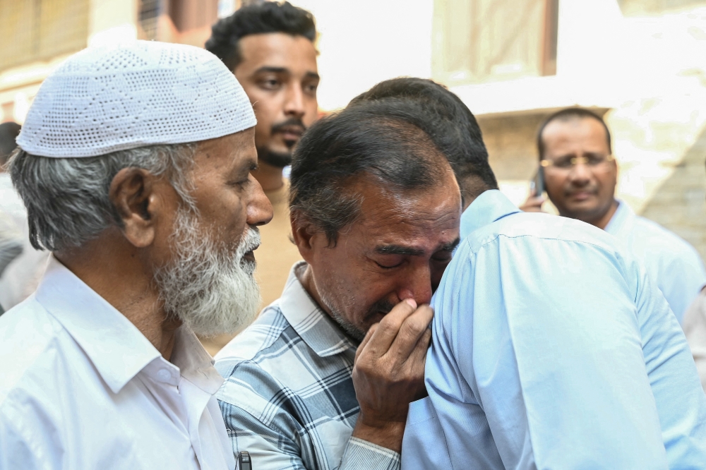Family members and relatives of victims, who were killed in a bus accident near the holy city of Medina, mourn in Hyderabad on November 17, 2025. — AFP pic
