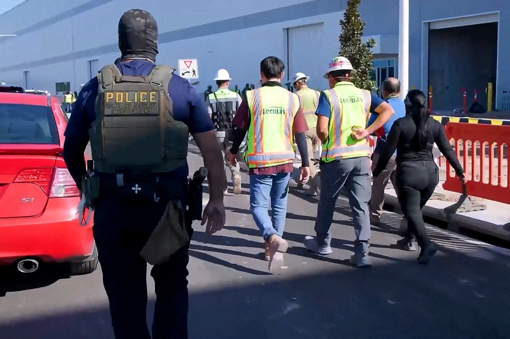 A masked federal agent guards a site during a raid linked to a US$4.3 billion Hyundai-LG battery project in Ellabell, Georgia on September 4, 2025. — Reuters pic
