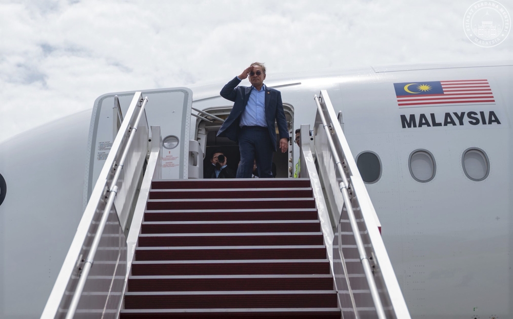 Prime Minister Datuk Seri Anwar Ibrahim salutes before embarking on his tour of three African nations, November 18, 2025. — Picture from Facebook/Anwar Ibrahim