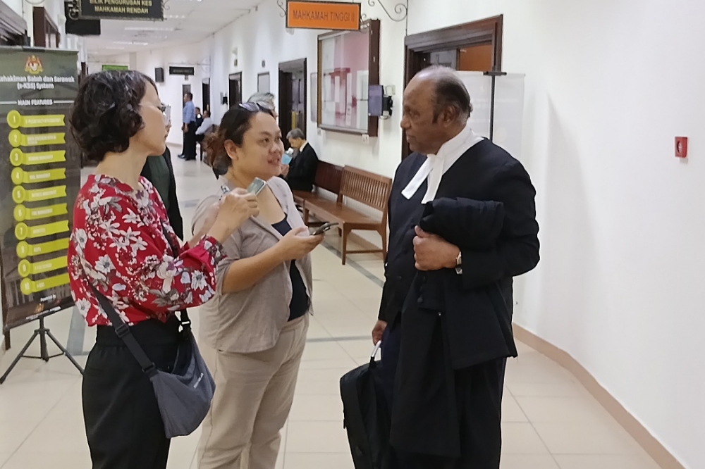 Cyrus (right) speaks to reporters after the proceedings today. — The Borneo Post pic