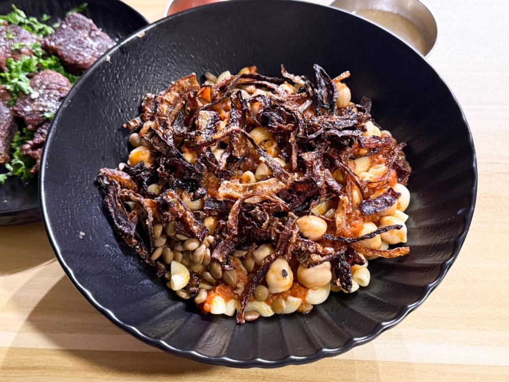 Koshari with its layers of rice and pasta combined with tomato sauce, lentils, chickpeas and fried onions is considered Egypt’s national dish. — Picture by Lee Khang Yi