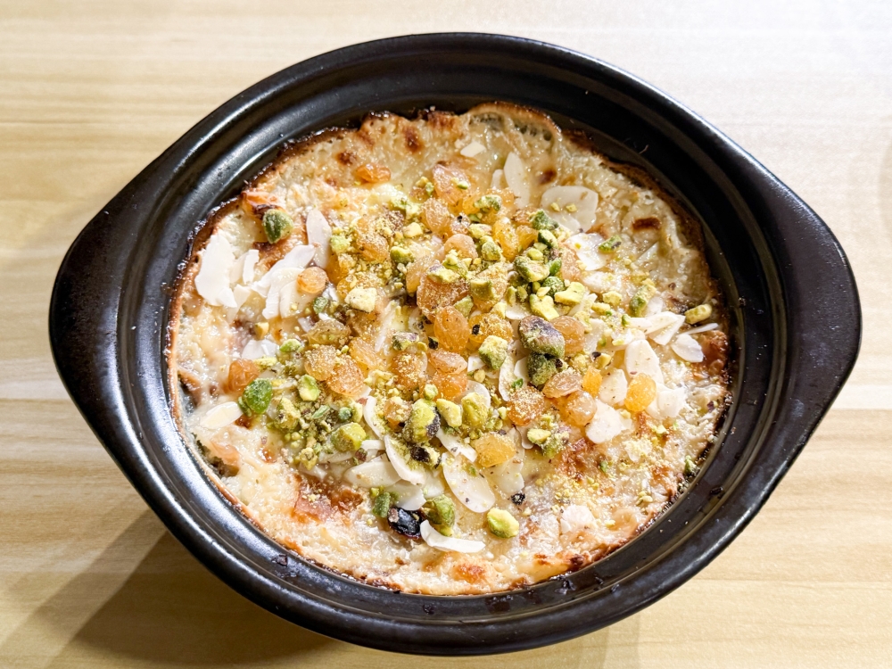 Dessert is Umm Ali, a traditional bread pudding with coconut, raisins and chopped nuts. — Picture by Lee Khang Yi