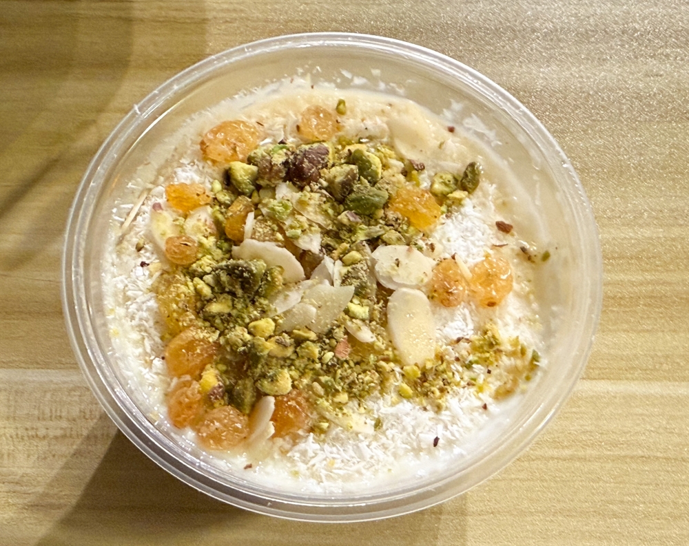 Mouhalabiya looks almost like Umm Ali with the same toppings but its texture is like a thickened milk pudding. — Picture by Lee Khang Yi