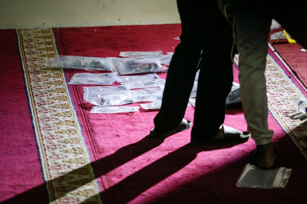 Police officials carry out an on-site investigation following a blast at a mosque inside a school in Jakarta on November 7, 2025. — AFP pic