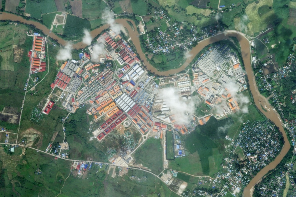 This handout satellite photo from Planet Labs PBC taken and received on November 9, 2025 shows the KK Park complex following a declared military crackdown that left some destruction at the scam compound in Myanmar's eastern Myawaddy township along the Moei River facing Mae Sot district (top and R) in Thailand's border province of Tak. — Planet Labs handout