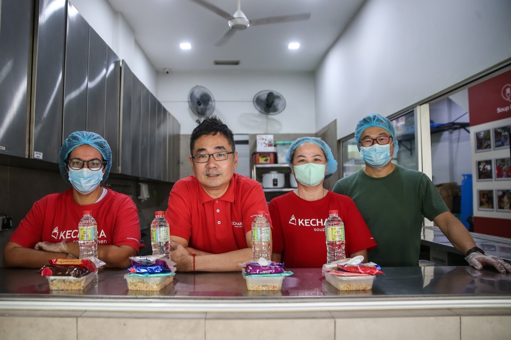 Kechara Soup Kitchen marketing and operation manager Justin Cheah (centre) said existing transit centres are too far for many who need them. — Picture by Yusof Isa
