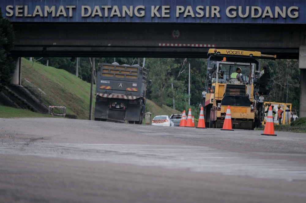 Workers carry out road repair works linked to the widening project along the Pasir Gudang Highway in Pasir Gudang, July 7, 2025. — Bernama pic
