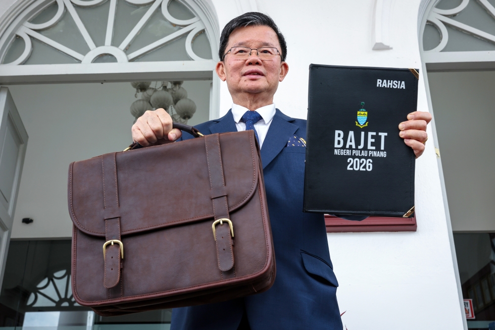 Penang Chief Minister Chow Kon Yeow holds up the 2026 state budget at the Penang Legislative Assembly in George Town today, November 14, 2025. — Bernama pic