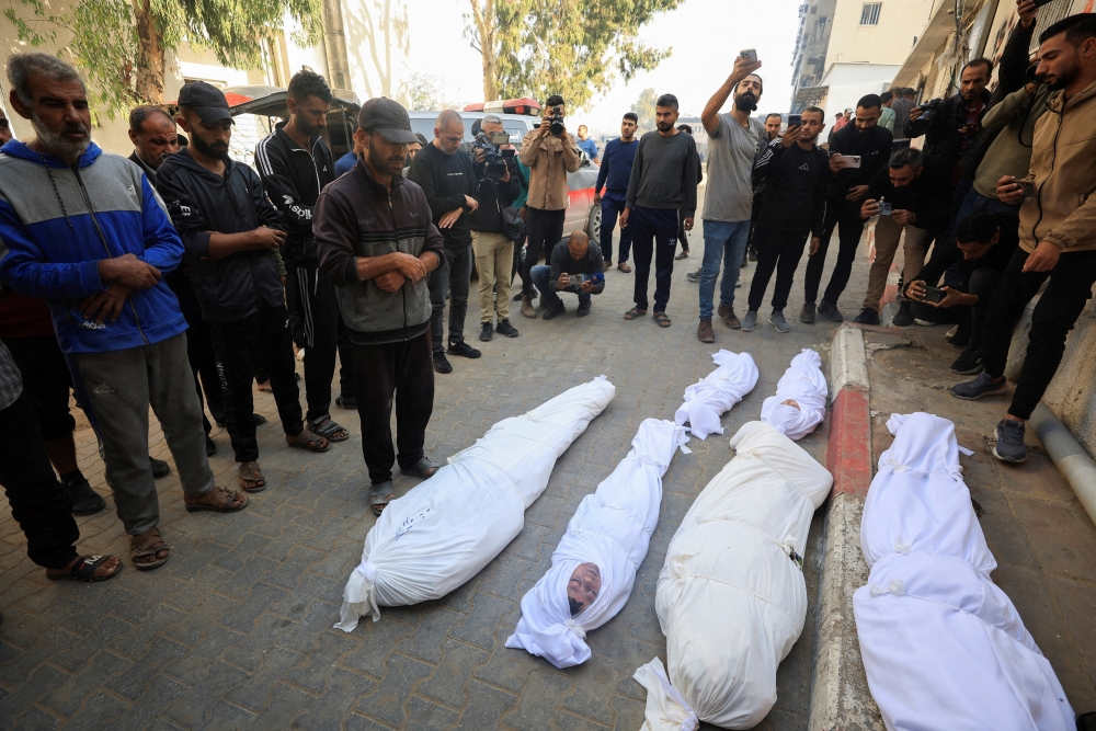 Mourners pray as they attend the funeral of Palestinians who, according to medics, were killed in overnight Israeli strikes, at Al-Shifa Hospital in Gaza City, November 20, 2025. — Reuters pic 