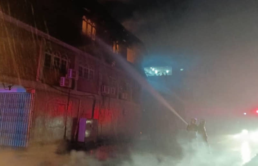 Firefighters battle the blaze at the massage centre. — Bomba pic via The Borneo Post 