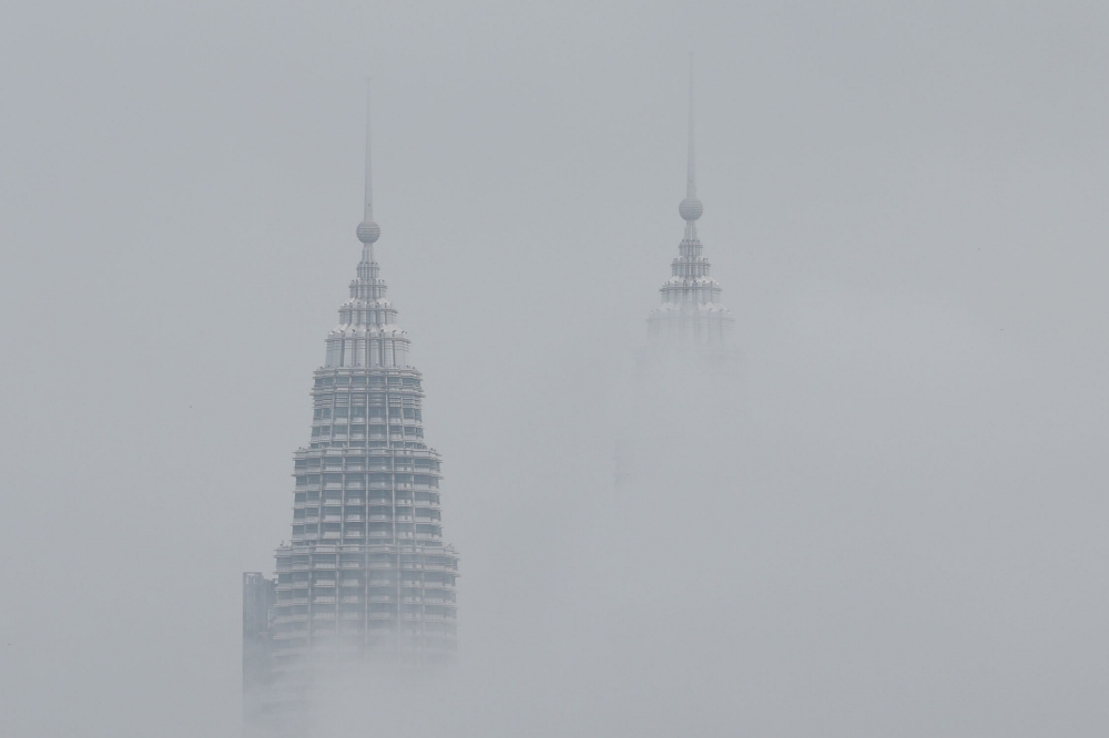 The Petronas Twin Towers are shrouded in rain clouds in Kuala Lumpur on November 18, 2025. — Bernama pic