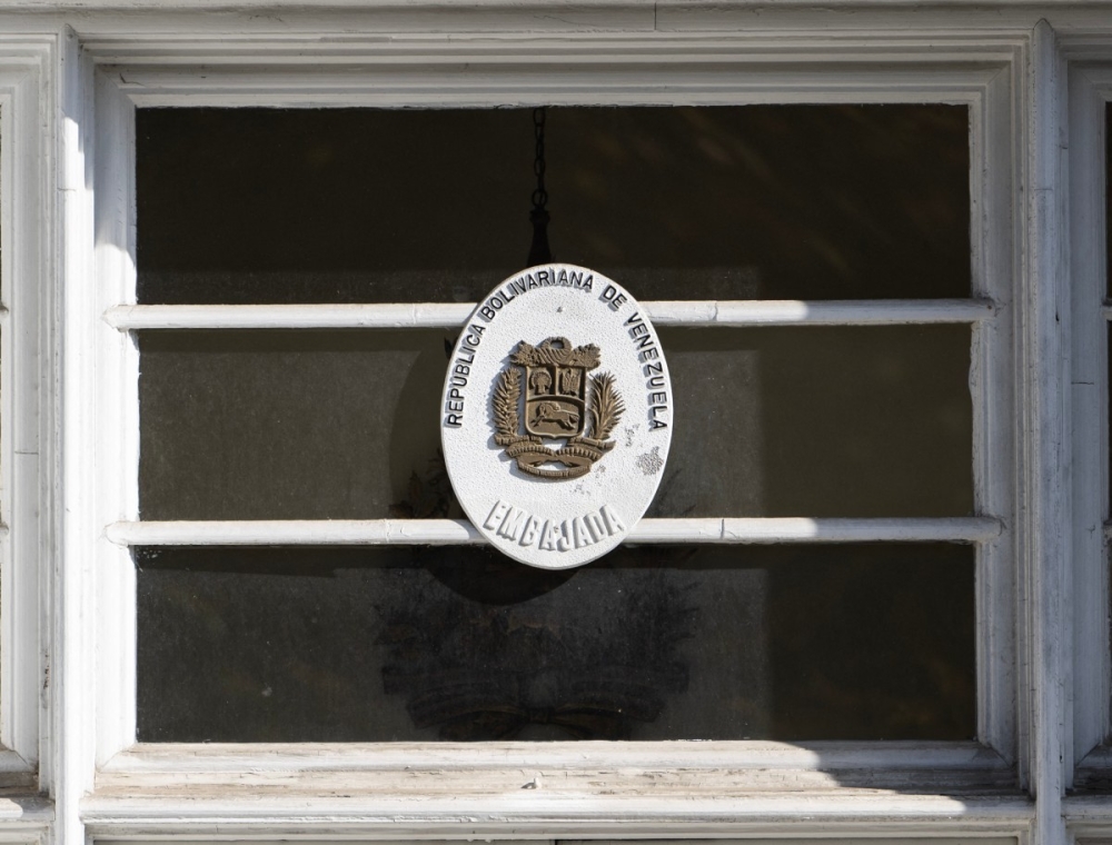 A government seal is posted above a weathered door at the former Venezuelan Embassy in Washington, DC on November 14, 2025. — AFP pic