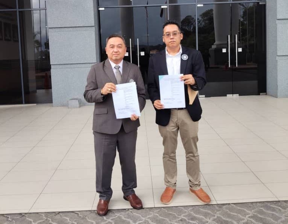 Pembela representatives Mohammad Jeffry Rosman (left) and Kenny Chong (right) at the Kota Kinabalu Court House on November 21, 2025