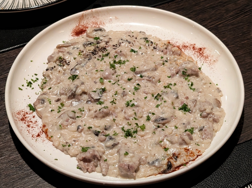 The ‘risotto salsiccia e funghi’ is so rich and thick it can be eaten off a flat plate with ease. — Photo by Ethan Lau