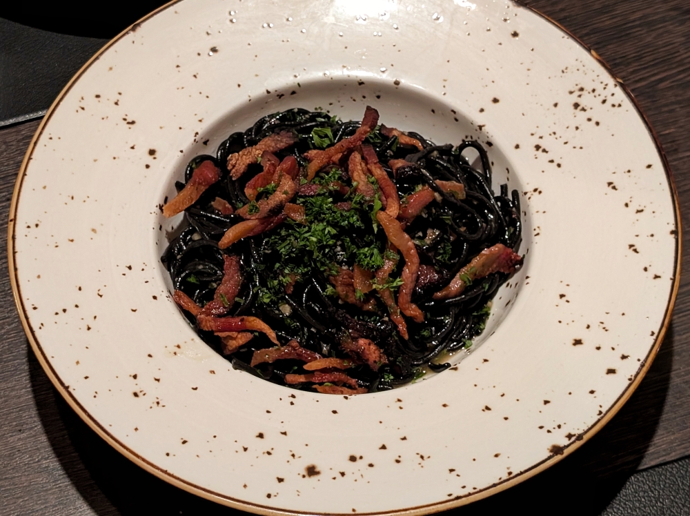 It looks simple, but the ‘spaghetti neri al guanciale’ is an excellent plate of pasta. — Photo by Ethan Lau