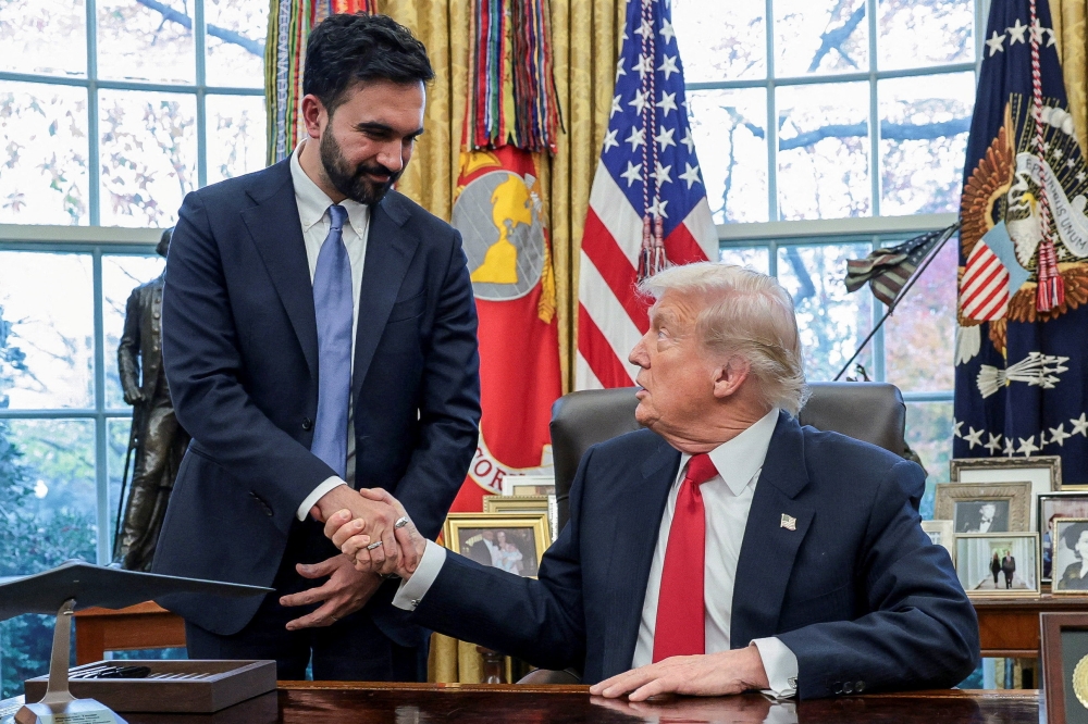 US President Donald Trump and New York City Mayor-elect Zohran Mamdani shake hands as they meet in the Oval Office at the White House in Washington, DC. — Reuters pic