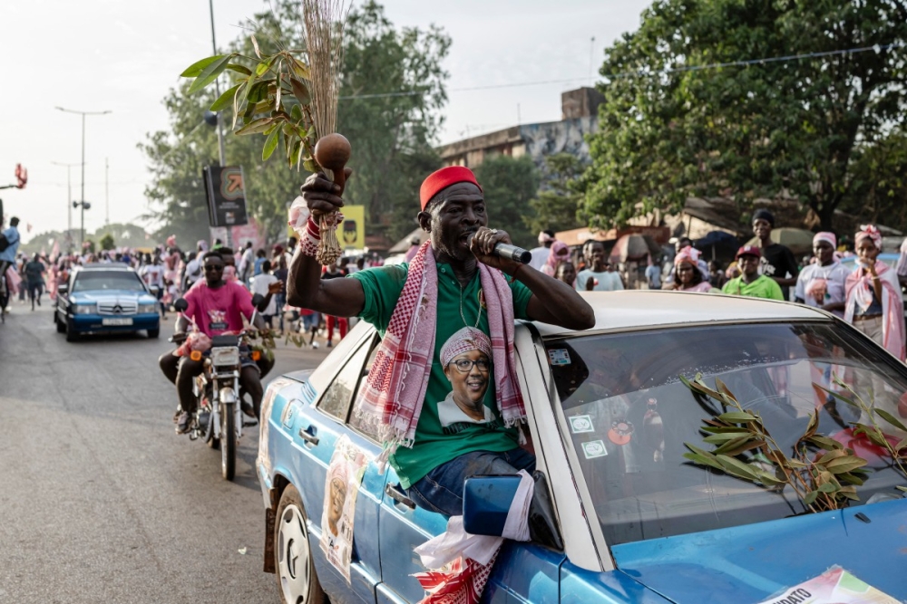 A supporter of Guinea-Bissau's President and presidential candidate Umaro Sissoco Embalo sings into a microphone during his final campaign rally ahead of general elections, in Bissau, on November 21, 2025. — AFP pic