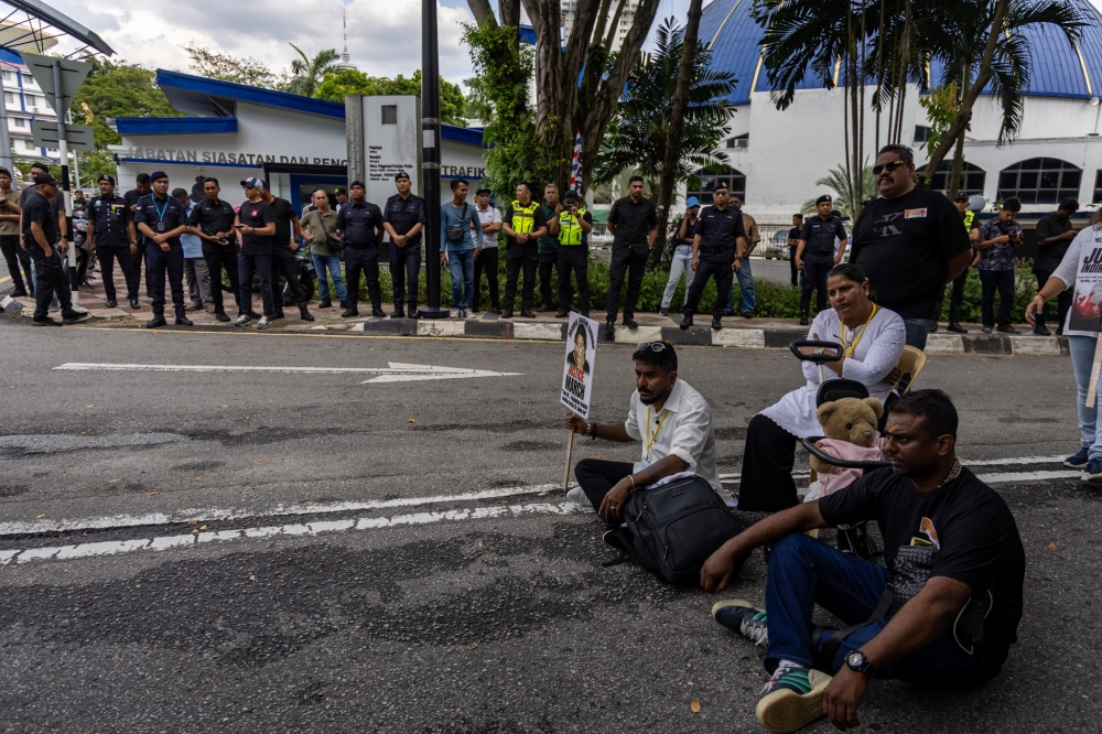 Indira Gandhi (seated on chair) and her supporters wait to meet Inspector-General of Police Tan Sri Mohd Khalid Ismail outside the federal police headquarters in Bukit Aman, Kuala Lumpur on November 22, 2025. — Picture by Firdaus Latif