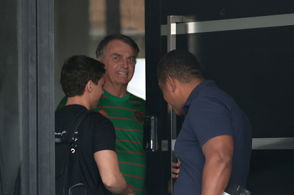 Brazil’s former President Jair Bolsonaro appears in the doorway of his house during his house arrest in Brasilia, Brazil, on November 21, 2025. — Reuters pic