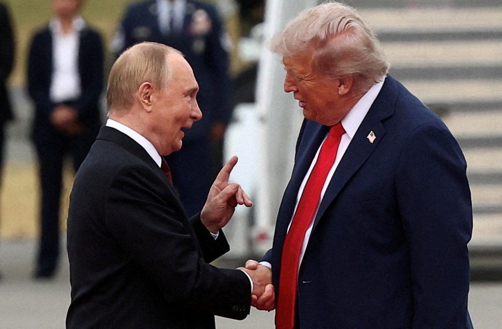 US President Donald Trump shakes hands with Russian President Vladimir Putin as they meet to negotiate for an end to the war in Ukraine, at Joint Base Elmendorf-Richardson in Anchorage, Alaska, on August 15, 2025. — Reuters pic