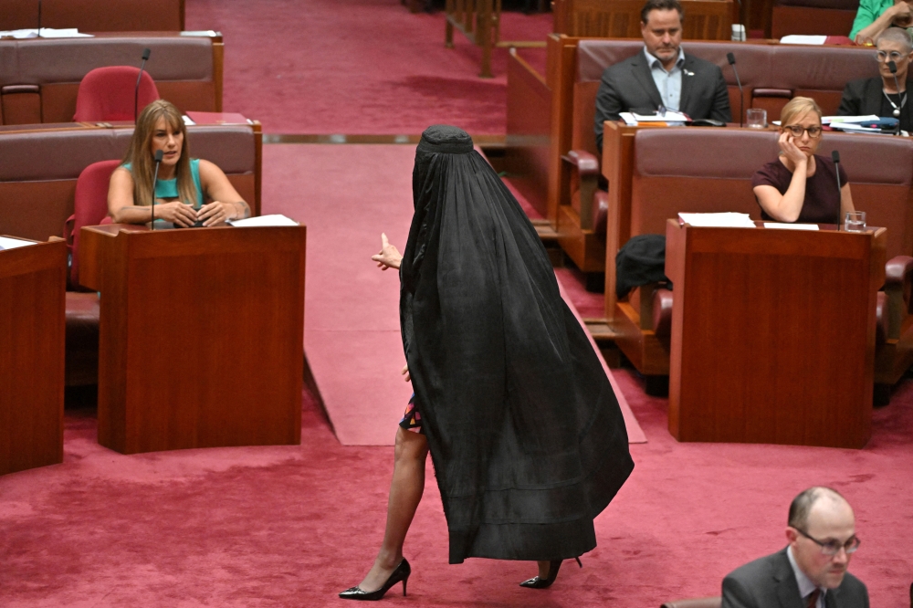 One Nation leader Pauline Hanson wears a burqa in the Senate chamber at Parliament House in Canberra, Australia, November 24, 2025. — Reuters pic