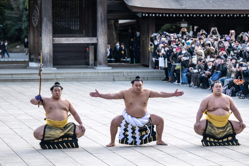 Mongolian born sumo wrestler and new yokozuna, or grand champion, Hoshoryu (C) performs the ring-entering ceremony at Meiji Shrine in Tokyo on January 31, 2025. — AFP pic