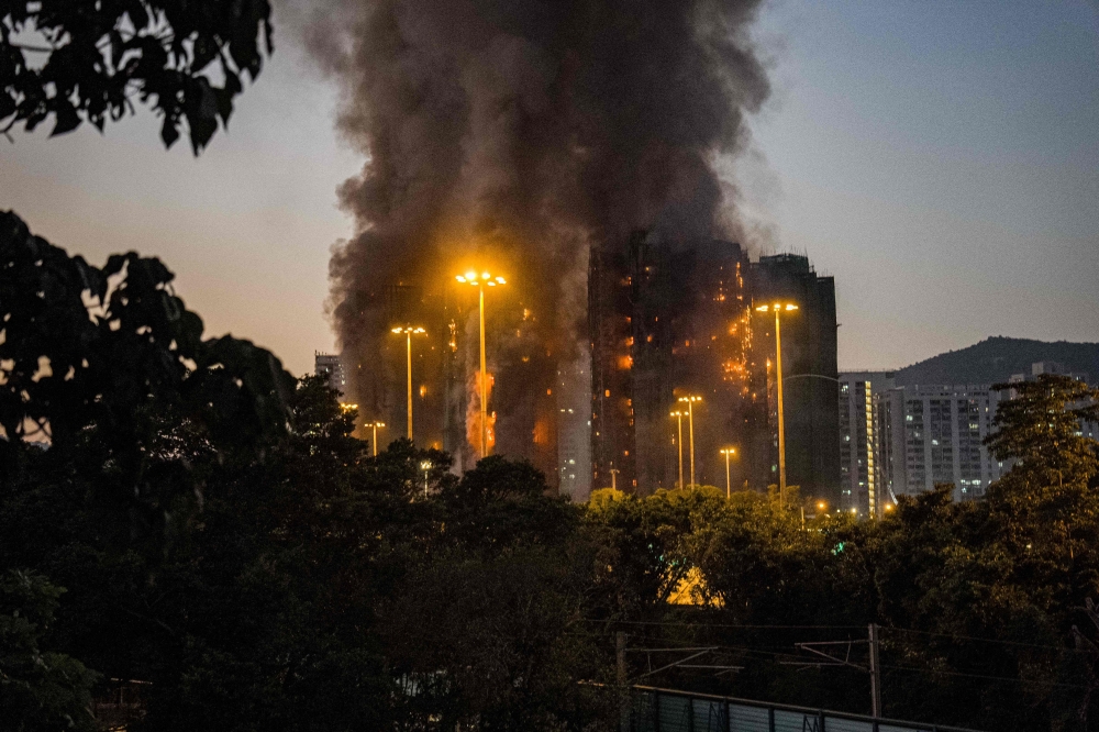 Thick smoke and flames rise as a major fire engulfs several apartment blocks at the Wang Fuk Court residential estate in Hong Kong’s Tai Po district on November 26, 2025. — AFP pic