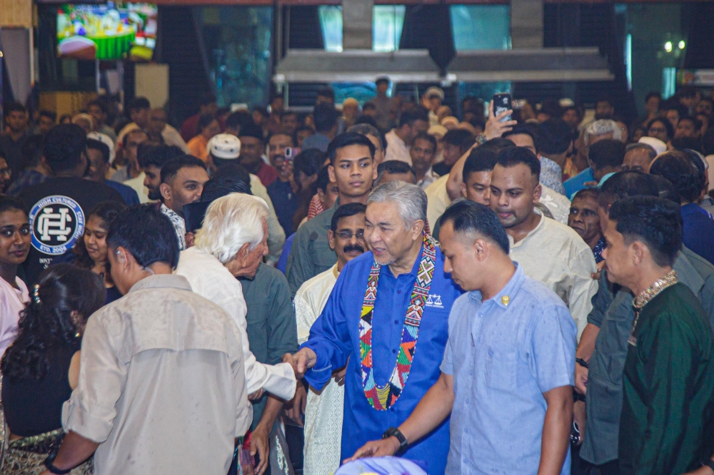 Ahmad Zahid greets members of the Indian community upon his arrival. — The Borneo Post pic
