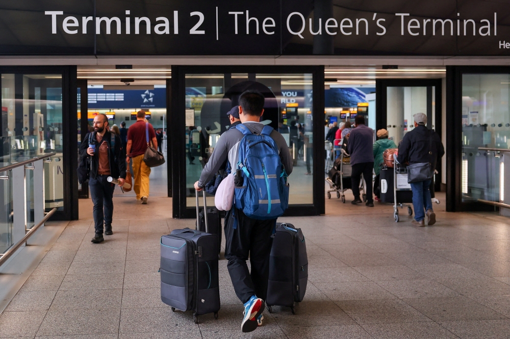 A traveller arrives at Heathrow Airport Terminal 2, amid flight delays and cancellations, resulting from a disruption to check-in and boarding systems caused by a cyberattack which has affected several major European airports, in Greater London September 20, 2025. — Reuters pic