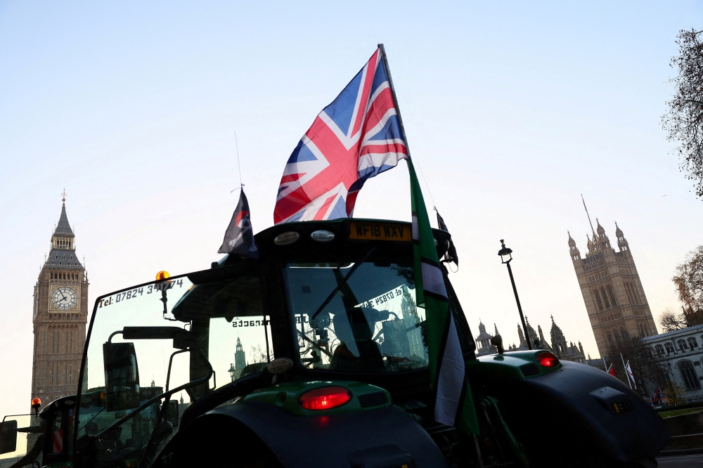 A tractor flies a Union Jack Flag near the near the Elizabeth Tower, commonly referred to as Big Ben, on the day of a planned Together Association and British farmers rally calling on British Chancellor of the Exchequer Rachel Reeves to scrap inheritance tax on family farms, on the day she is to present the Autumn Budget Statement to Parliament, in London November 26, 2025. — Reuters pic