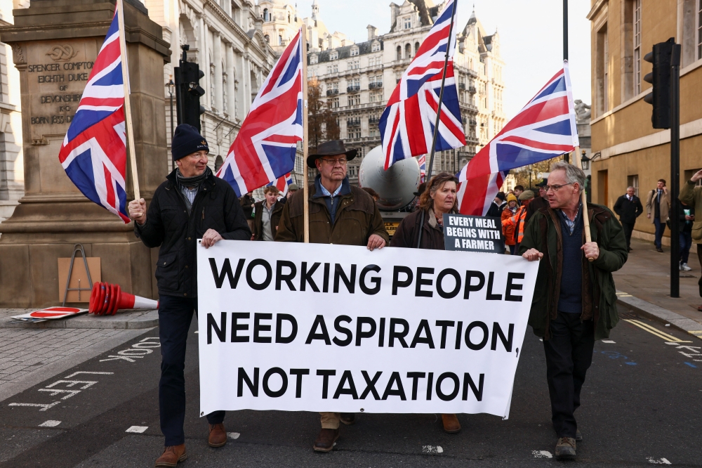 British farmers take part in a protest in the area of Whitehall, calling on British Chancellor of the Exchequer Rachel Reeves to scrap inheritance tax on family farms, on the day she presents the Autumn Budget Statement to Parliament, in London November 26, 2025. — Reuters pic