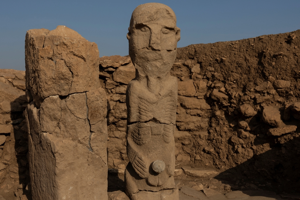 A pillar and a human statue stand at the Karahantepe excavation site, widely regarded with Gobeklitepe as keys to understanding the birth of symbolic thought, social complexity and monumental architecture thousands of years before cities or states existed, near the southeastern city of Sanliurfa Turkiye November 25, 2025. — Reuters pic
