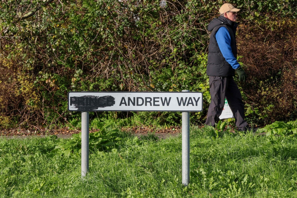 A pedestrian walks past a sign for a street originally named after Britain’s former prince Andrew, with the title of ‘prince’ blackened out, along a road in the town of Carrickfergus, County Antrim in Northern Ireland November 25, 2025. — AFP pic 