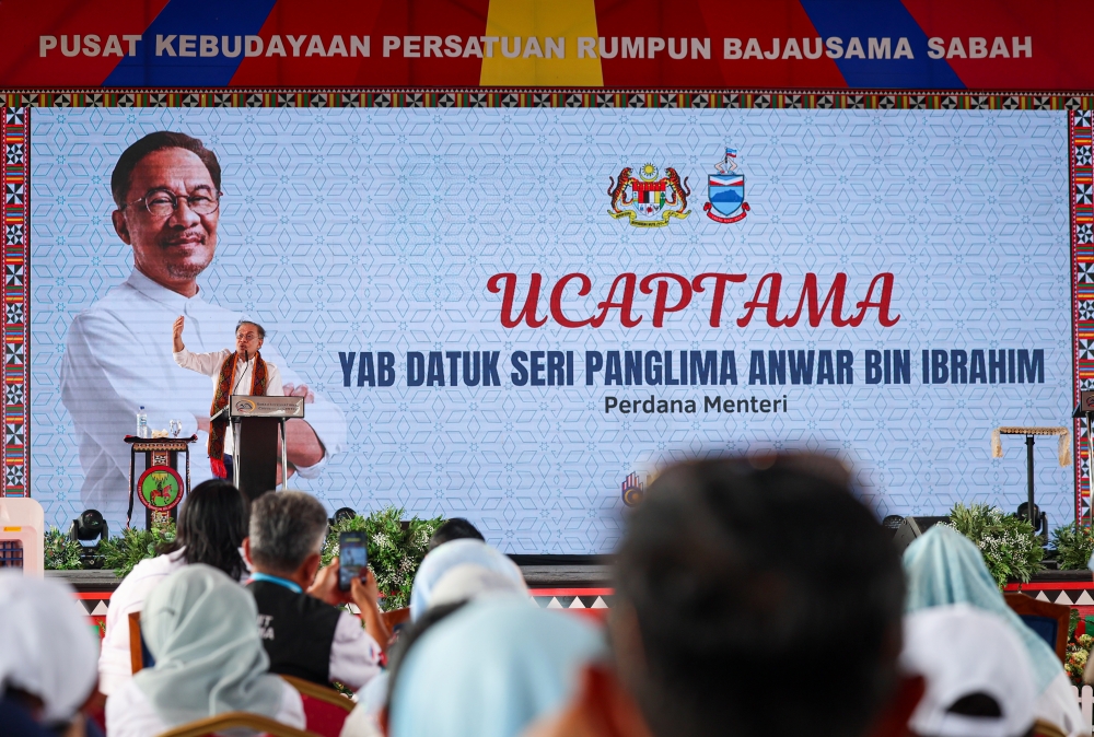 Prime Minister Datuk Seri Anwar Ibrahim delivers his keynote address at a meeting with local community leaders and Tuaran entrepreneurs at the Bajau Samah Cultural Centre, Sulaman, Tuaran today. — Bernama pic