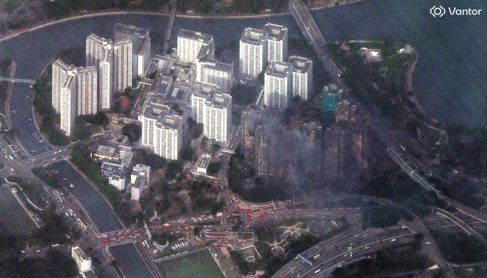 This handout satellite image by Vantor taken and made available on November 27, 2025 shows smoke rising from apartments after a major fire swept through several blocks at the Wang Fuk Court residential estate in Hong Kong’s Tai Po district. — 2025 Vantor satellite image handout pic via AFP 