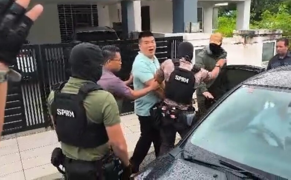 Businessman Albert Tei was arrested this morning by the MACC and police before being released minutes later, according to his lawyer Zaid Malek. — Screengrab courtesy of Zaid Malek