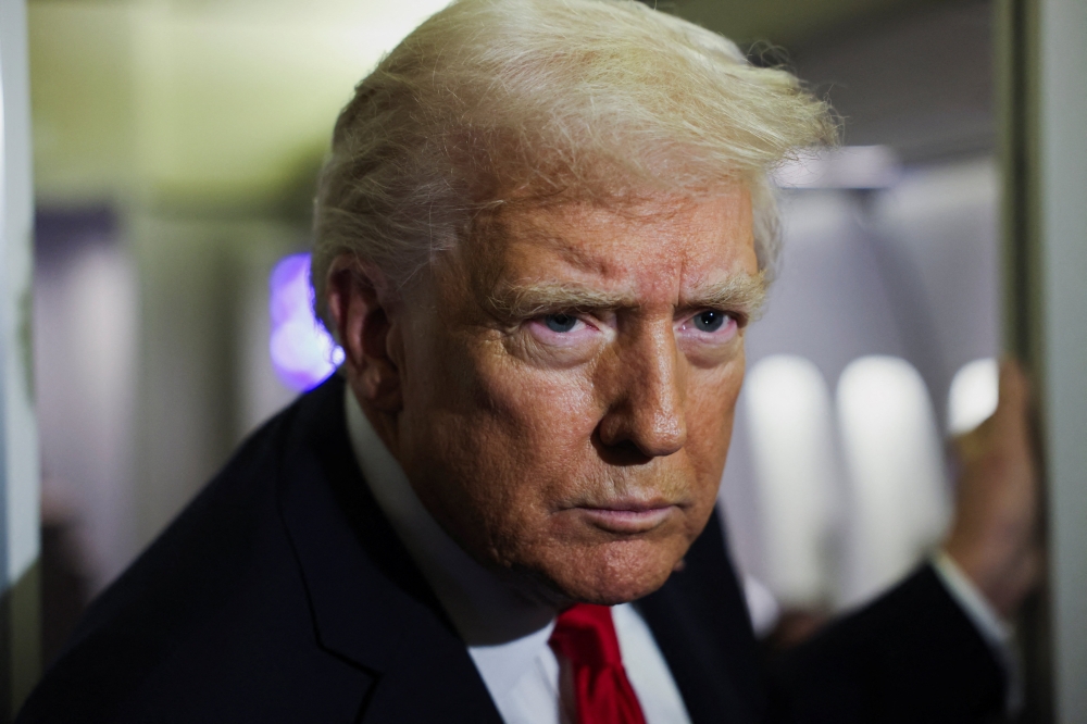 US President Donald Trump looks on aboard Air Force One during travel to Palm Beach, Florida, from Joint Base Andrews, Maryland, US, on November 25, 2025. — Reuters pic