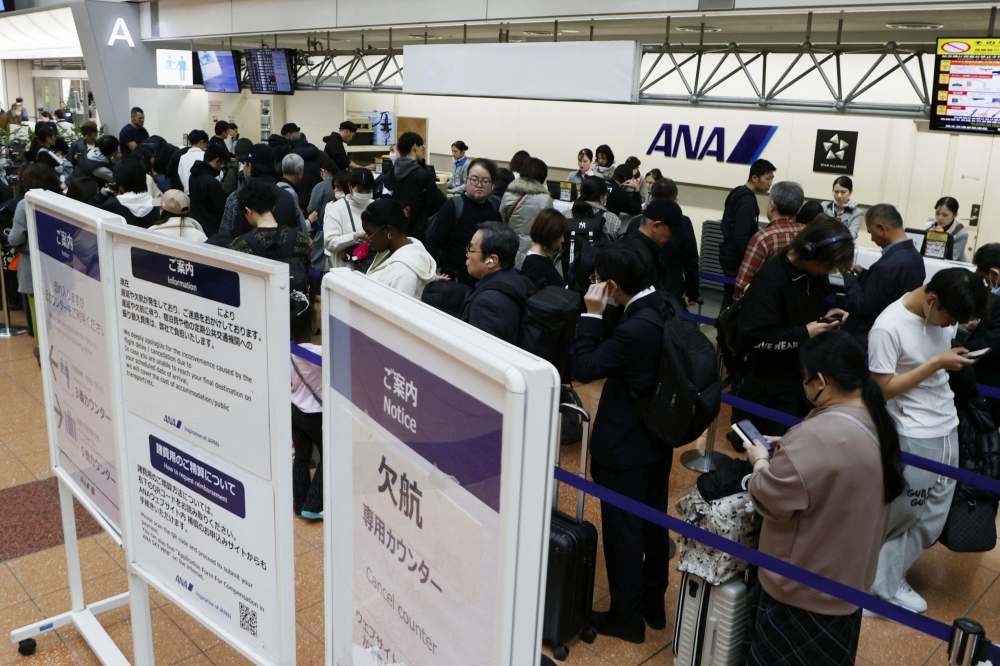 Passengers queue at All Nippon Airways’ (ANA) cancellation counter after the company cancelled flights due to the Airbus A320 recall which forced it to ground some aircrafts at Haneda Airport in Tokyo, Japan November 29, 2025, in this photo taken by Kyodo. — Reuters pic