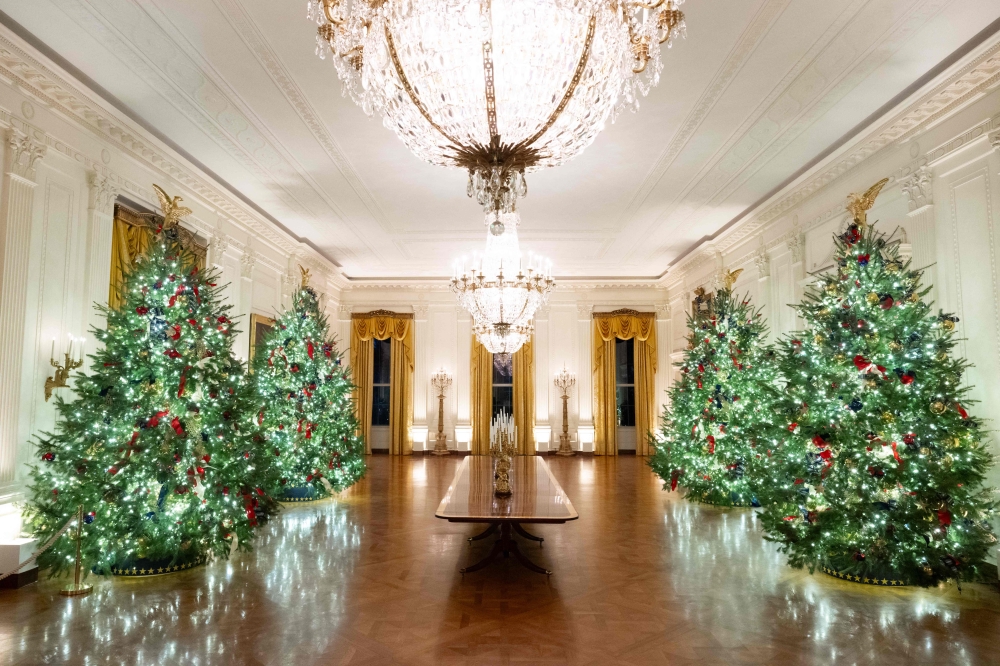 Christmas trees and decorations are seen in the East Room of the White House in Washington. — AFP pic 