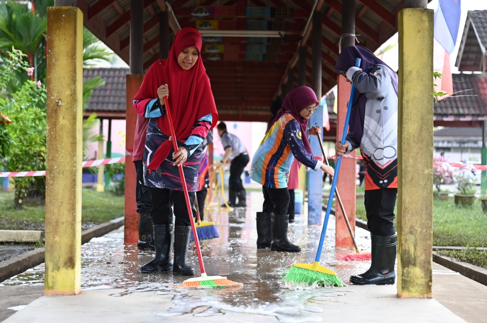 Teachers clean up school areas affected by floods during the Post-Flood School Cleaning Programme at Sekolah Kebangsaan Kedai Buloh, Kuala Terengganu, December 2, 2025. — Bernama pic 
