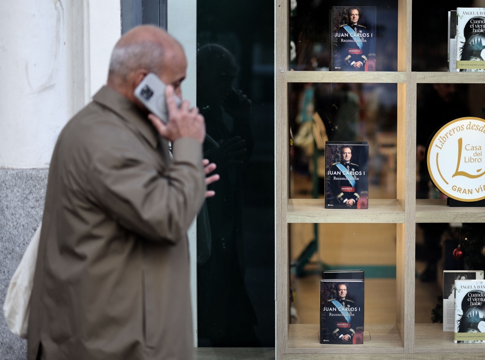 A man walks past the book ‘Juan Carlos I. Reconciliation’, former Spanish King Juan Carlos’s memoirs, released in Spain on December 3, 2025, in a bookshop in Madrid. — AFP pic 
