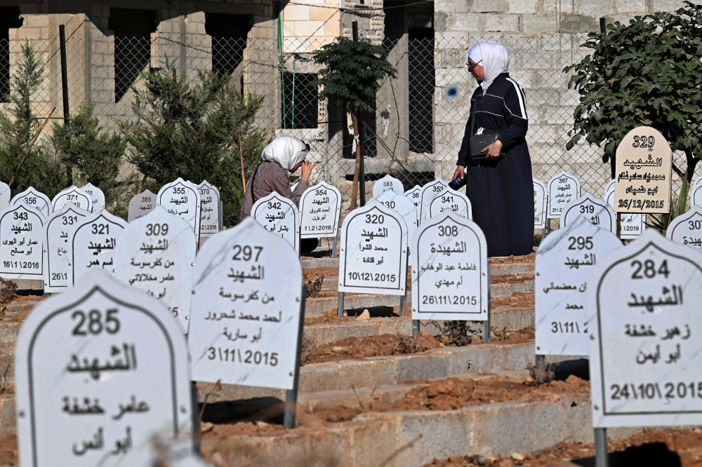 A woman visits a grave in the ‘Cemetery of Martyrs’ in Daraya, a suburb that lies just south-west of the centre of the capital Damascus on October 28, 2025. — AFP pic 