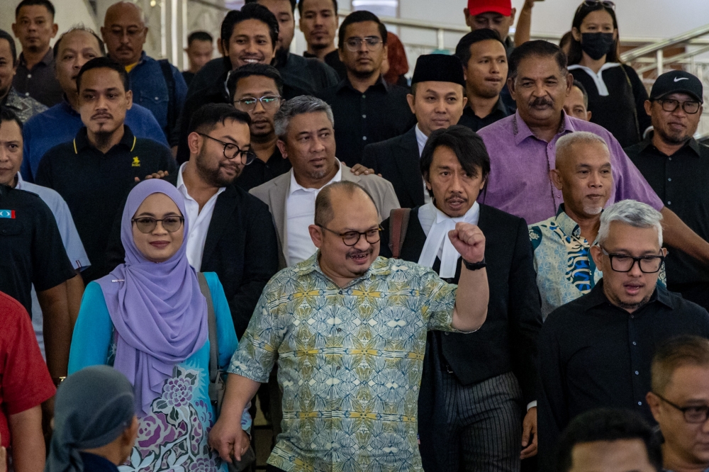 Former senior political secretary to the prime minister, Datuk Seri Shamsul Iskandar Mohd Akin (centre), is pictured at the Kuala Lumpur Court Complex in Kuala Lumpur on December 4, 2025. — Picture by Firdaus Latif