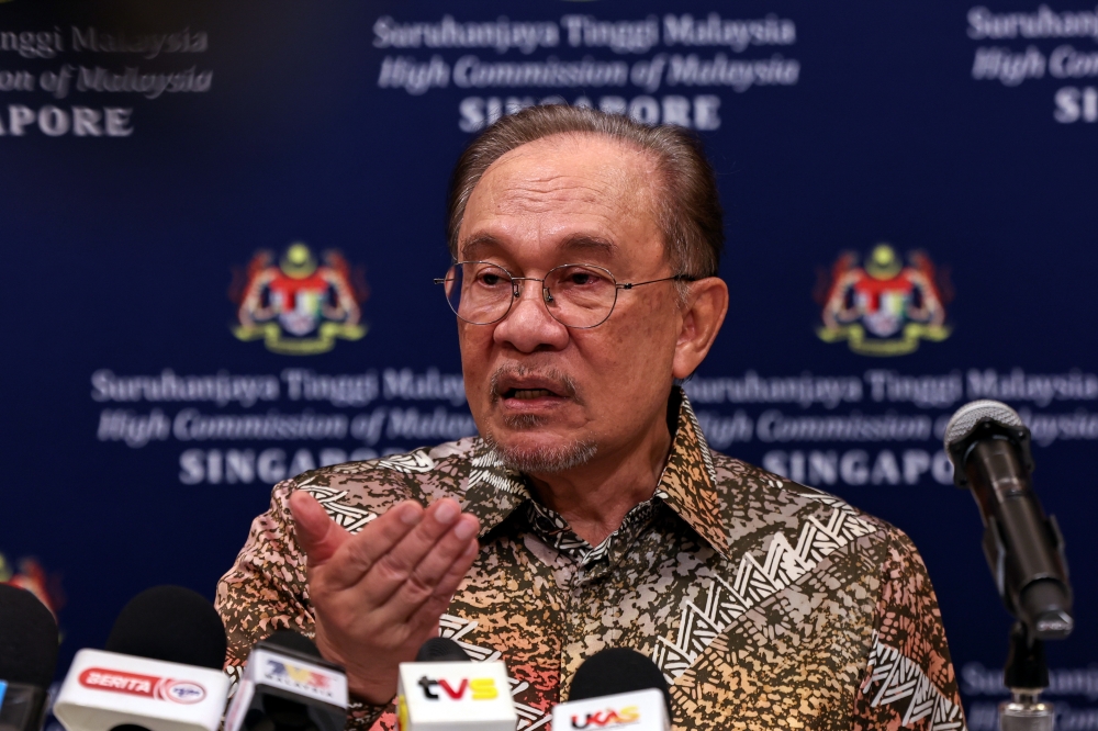 Prime Minister Datuk Seri Anwar Ibrahim speaks at a press conference after attending the 12th Malaysia–Singapore Leaders’ Retreat in Singapore today. — Bernama pic