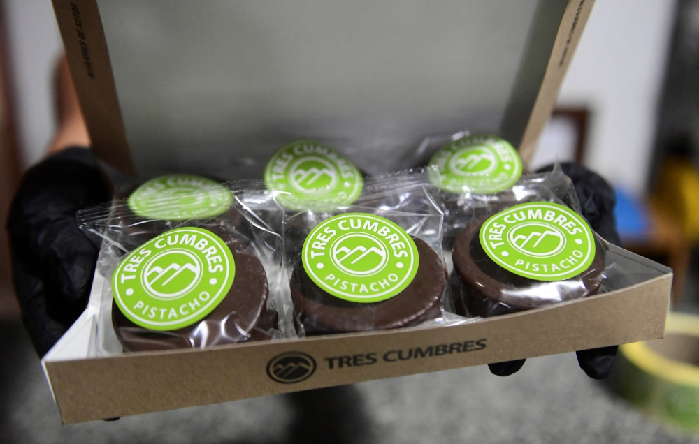 A worker of Tres Cumbres holds a box with pistachio ‘alfajores’, a traditional Argentine cookie, at the Tres Cumbres factory in San Juan, Argentina, November 18, 2025. — Reuters pic 