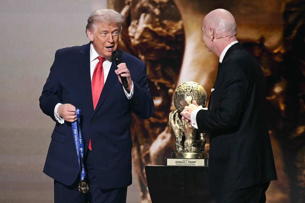 US President Donald Trump speaks as he receives the FIFA Peace Prize alongside FIFA President Gianni Infantino during the draw for the 2026 FIFA Football World Cup taking place in the US, Canada and Mexico, at the Kennedy Center, in Washington, DC, on December 5, 2025. — AFP pic