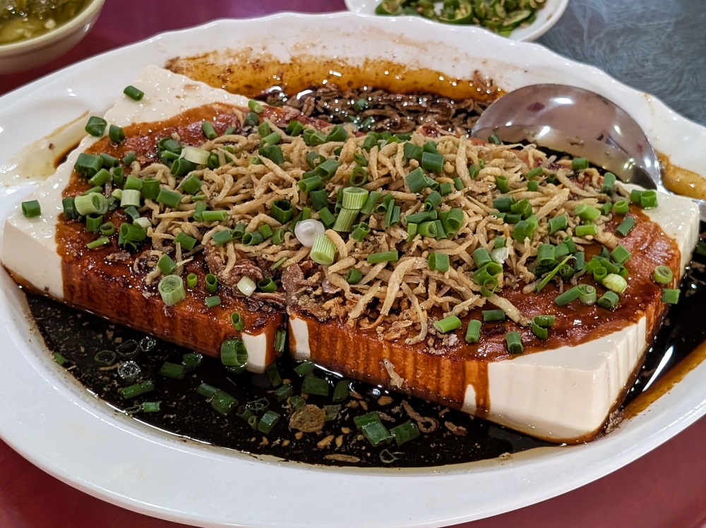 The cold tofu is a standout, particularly because of the seasoned soy sauce mixture poured on top of it. — Picture by Ethan Lau